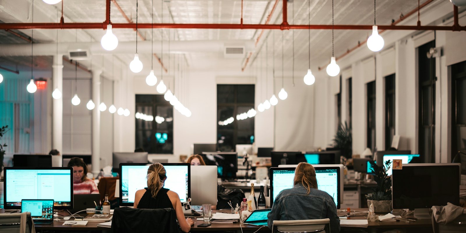 People working at computers in a large open-plan office
