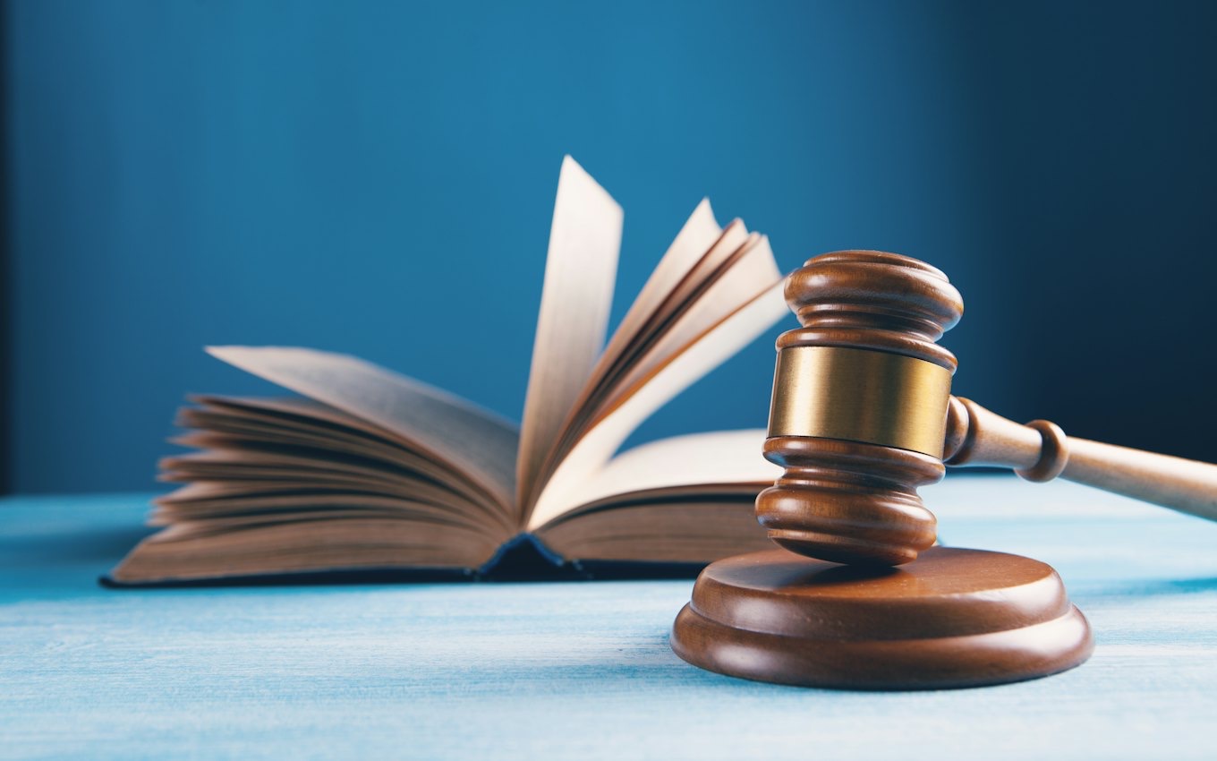 A judge's gavel resting on an open book
