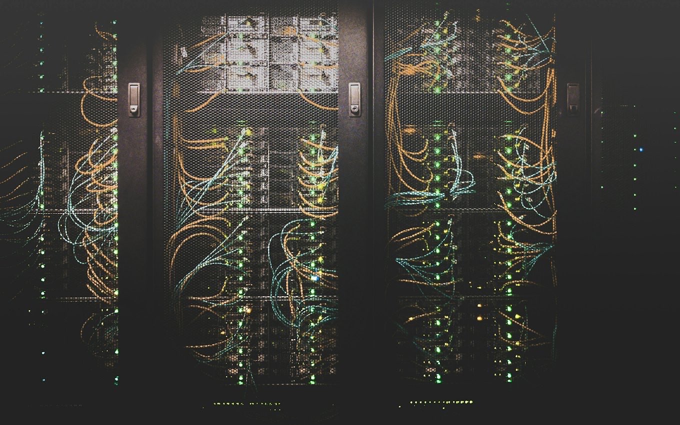 Rows of network cables plugged into data center servers